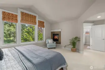Spacious and inviting primary suite features a gas fireplace.