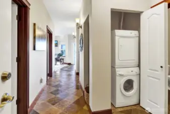 The closet accommodates the stacked washer/dryer just outside the bathroom door.
