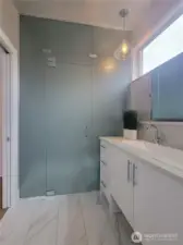 Primary bathroom featuring a frosted glass privacy enclosure.