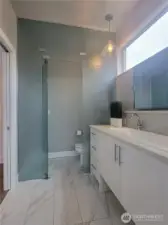 Primary bathroom featuring a frosted glass privacy enclosure.