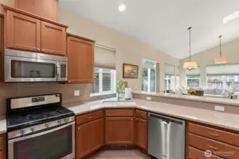 Gas range flanked by alder cabinets bring this kitchen up a notch.
