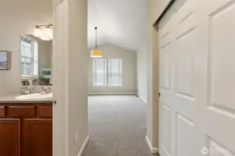 View into the second bedroom showing the bathroom entry on the left.