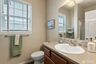 Second bathroom, quartz counters and custom tile backsplash.