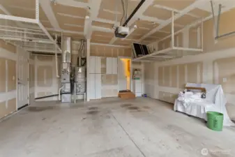 Two car garage with ceiling storage and "man door" to side yard.