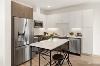 This chic kitchen is outfitted with quartz counters, high-end Bertazzoni appliances, a gas stove and pantry.