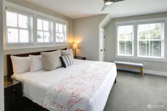 ...you will find the tree house like primary bedroom.  Surrounded by windows and territorial views, this retreat is private and quiet.