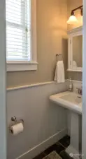 Off the entry is a guest powder room.