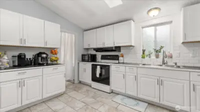 Bright Kitchen with plenty of cabinets and skylight