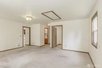 Looking the other direction in the bonus room. Past the half bath is the door to the garage and the walk in pantry is on the right.