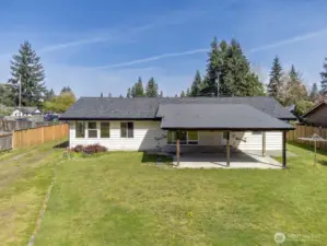 There is plenty of room to the left of the home to access the driveway to the detached shop.