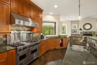 Cooking and entertaining is delightful with the Viking 6 burner range + grill + double oven, custom cabinetry and prep sink