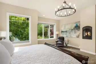 Simple luxuries like the gas fireplace, reading nook and extra large windows overlooking gardens complete the large Primary Bedroom