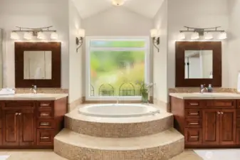 An extraordinary spa bathroom is the crowning touch in the primary suite. His and hers walk in closets and a jetted soaking tub with etched glass window are revealed upon opening the French paneled doors