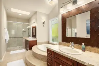 The over sized frameless shower, skylight and his and hers vanities complete the spa bathroom