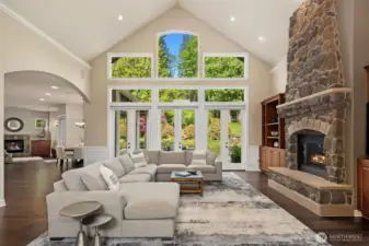 Floor to ceiling windows with three sets of French doors make indoor-outdoor living possible any time of the year! The Great Room is one of several with built in Dolby Digital 7.1 surround sound system and gas fireplace.