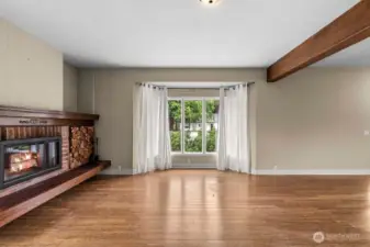 Spacious living room with built in wood fire place.