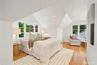 Upstairs this is the larger of the two bedrooms. Love the peaked ceilings and big windows!