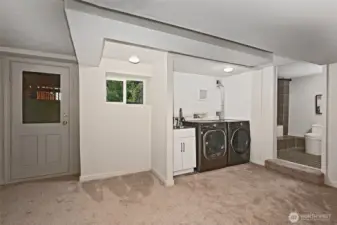 Laundry area with a utility sink. Door to the backyard- could be a separate entrance for an ADU or MIL
