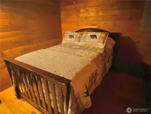 Full size bed in downstairs guest room.