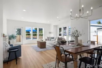 Another view across the dining area toward the living room with the water views beyond.