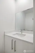There is a half bath in the hallway near the office space.