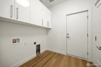 The laundry room is conveniently located adjacent to the garage, and has a large storage/coat closet.