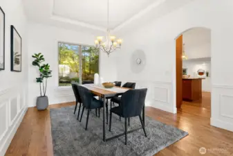 Huge dining room with coved ceiling (with lighting!) and classic box wall molding.