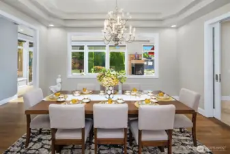 Bright Dining room has a coved ceiling & glass pocket door