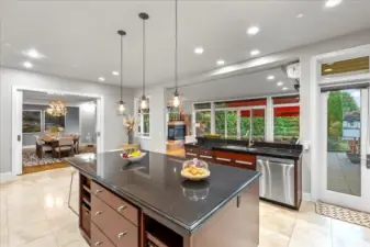 The Kitchen is the heart of the home and open to the formal dining room, informal dining room, living room, and a door straight out to the deck