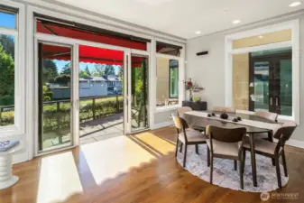 Informal dining room opens to deck overlooking the canal. It could also be used as a second living room