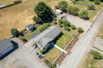Solar panels can be seen on back side of garage and creative cottage. Beautiful double property- one lot with home and detached garage, pastures and horse arena and pastures and barn on other. Lot with barn structure is buildable for a home, plus ADU- buyer to verify to satisfaction. Rare opportunity in Tacoma! (Grassy lot behind not part of the sale)