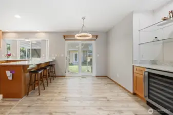The kitchen was remodeled in 2023 and features quartz countertops, upgraded hardwood cabinetry, and durable LVP flooring. A built-in 48-bottle wine fridge completes the space.