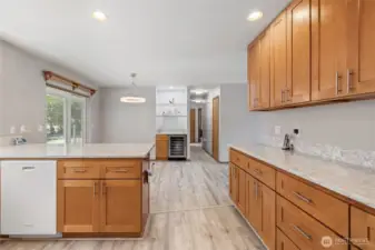 The kitchen was remodeled in 2023 and features quartz countertops, upgraded hardwood cabinetry, and durable LVP flooring. A built-in 48-bottle wine fridge completes the space.