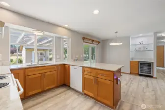 The kitchen was remodeled in 2023 and features quartz countertops, upgraded hardwood cabinetry, and durable LVP flooring. A built-in 48-bottle wine fridge completes the space.