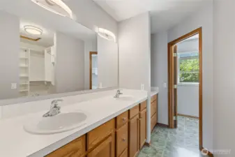 The primary suite is thoughtfully designed with custom California Closets and an ensuite bath. The bathroom features a six-foot soaking tub and a cable TV hookup, and all rooms in the home are wired for cable, including the primary bath.