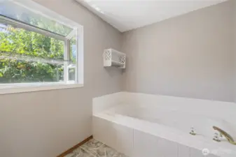 Custom California Closets enhance both the pantry and primary suite. The primary bath features a six-foot soaking tub and a cable TV hookup.