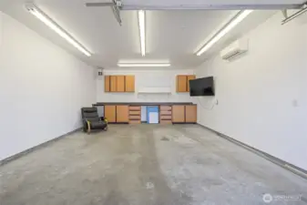 The garage and shop are fully insulated and equipped with a ductless heat pump for year-round usability. The space is piped for an air compressor, which stays with the property, and includes a 50-amp outlet for electric vehicle charging. Built-in cabinetry and a mini fridge are included, along with a dedicated gun safe cabinet (safe not included). A 220-volt welding plug and a 200-amp service panel support a wide range of uses.