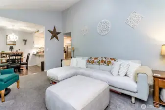 Spacious living room with natural light and vaulted ceilings.