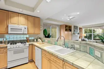 Lovely tile counter tops with double sink, gas stove and dishwasher. Both the corners of the counter top have built in lazy Susans. So light and open to the living area. again the slider on the lest to the long 2nd patio, picture windows to the park like 1st patio. Both of the patios can be used for entertaining and BBQ's. This home has such a nice corner layout with all of the extra outdoor space to enjoy and entertain with for you and your quests.