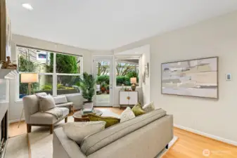 Now you can see out at the patio. I mean this is like your own private park. This a large patio with plenty of space for planters (asyou can see), outdoor furniture and bbq. Look at all the natural light coming into the living room.