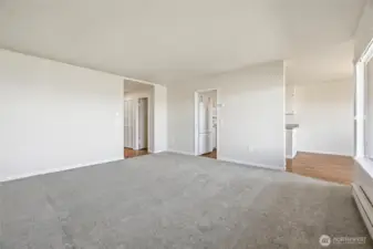 View of entryways to hallways, kitchen and dining area
