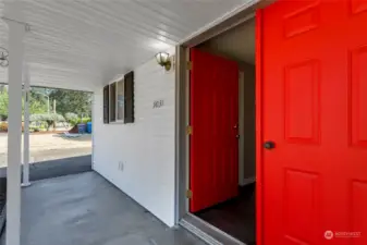 Covered front patio with double door entry.