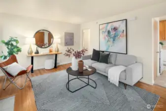 Living room of Unit 2218, wood burning fireplace and oak hardwoods throughout. It’s now vacant and staged.