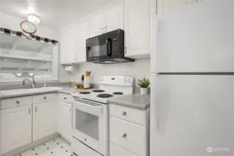 From the kitchen sink you can look out into your spacious covered patio and backyard.