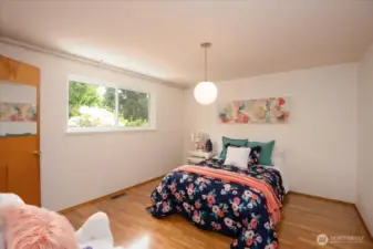 3rd bedroom with walk in closet overlooking the backyard.  Queen size bed