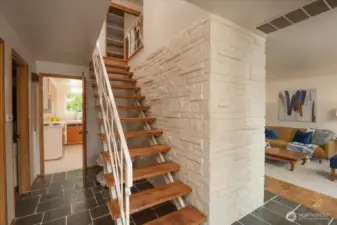 As you enter take in the Midcentury architecture. To the left is an office or 5th bedroom. Living and formal dinning to the right. Full bath and kitchen straight ahead.