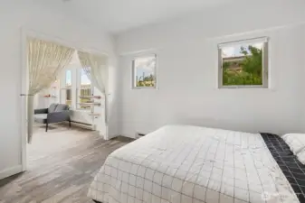 Bright windows in the bedroom let in the morning light