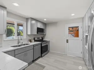 Soft close doors and drawers, gleaming new appliances and stunning countertops complete these top notch kitchen. It's not often you find a kitchen like this in a home of this size.