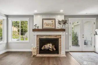 A newer gas fireplace with a brick surround and fan to push out heat keeps you cozy on rainy winter evenings.