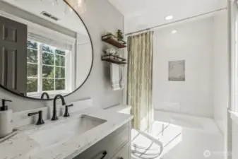This stylishly appointed ensuite bathroom was redone in 2021 with new fixtures, toilet, tub, vanity and tile floors.